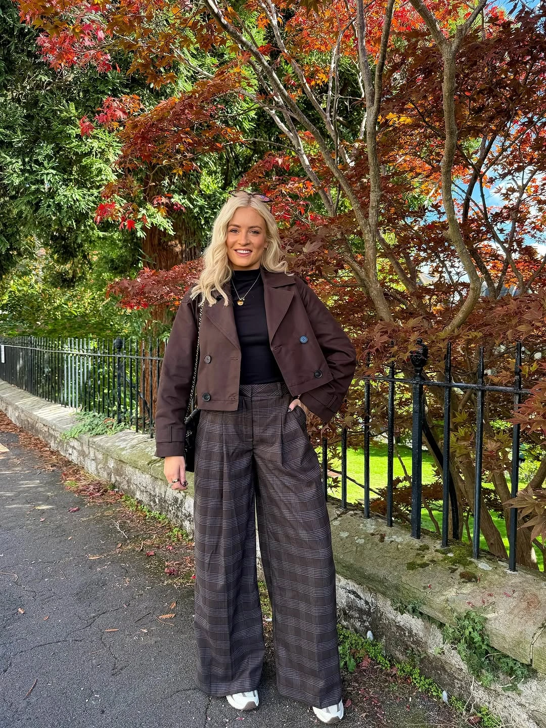 burgundy outfit with cropped jacket over wide high-waisted plaid trousers