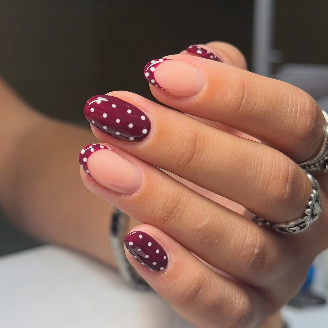 Burgundy almond nails with white dotted curved panels
