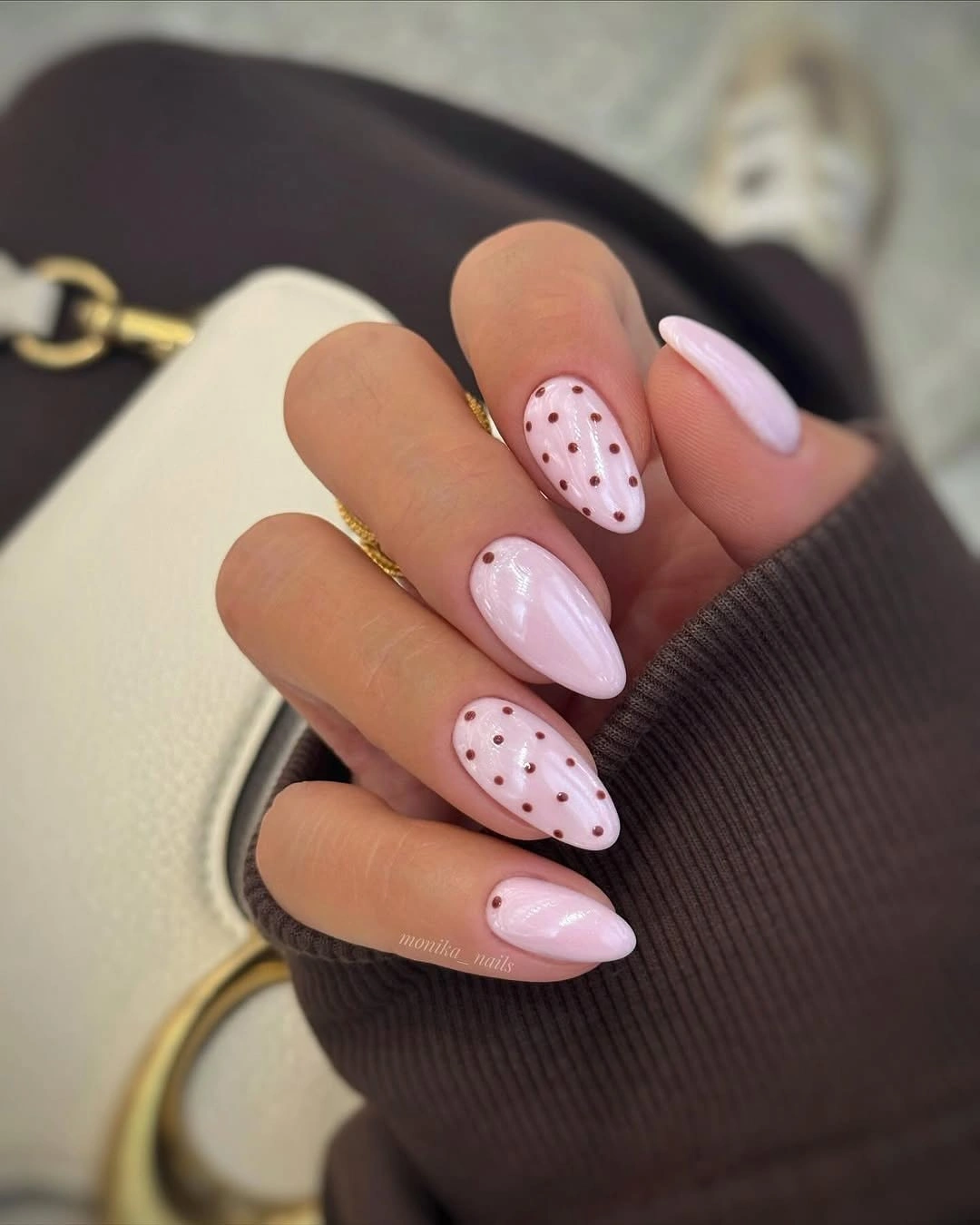 Pale pink almond nails with sparse burgundy dots