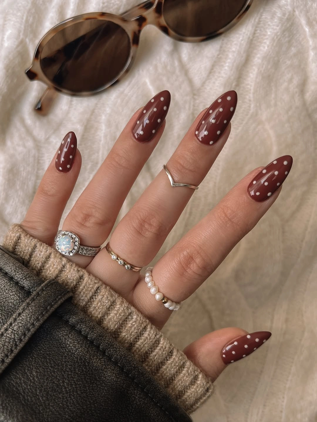 Warm cocoa almond nails with loosely spaced white dots