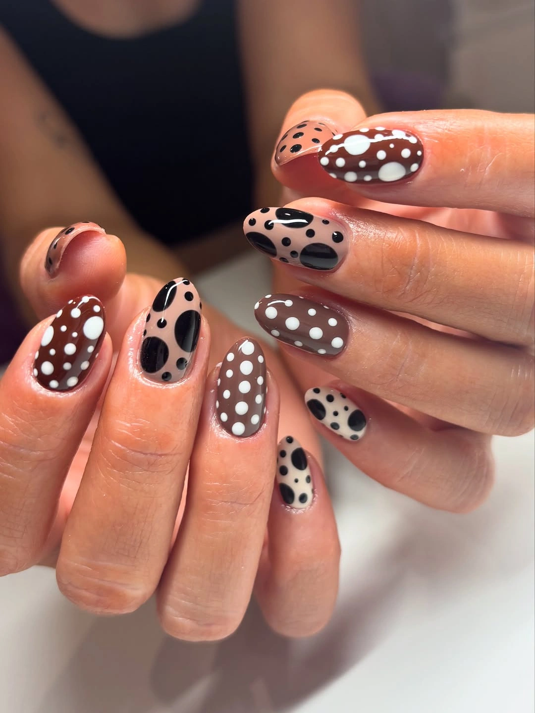 Neutral rounded nails with large dots and oval spots