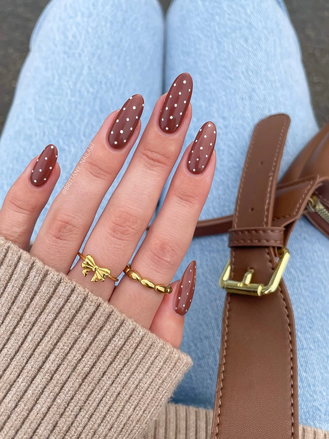 Warm brown almond nails with small white dots