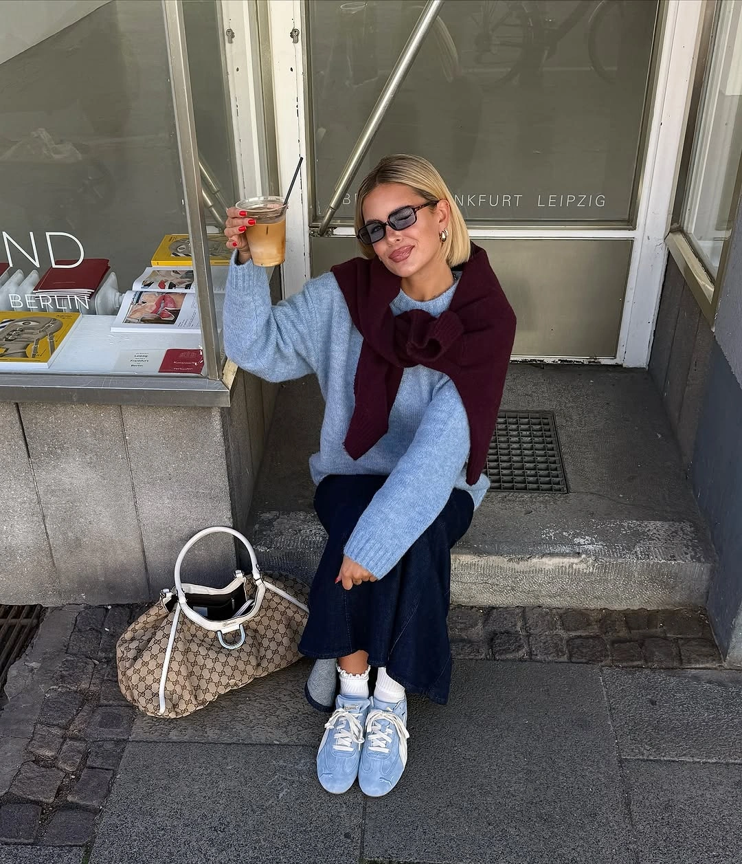Pale blue sweater with burgundy scarf and wide trousers