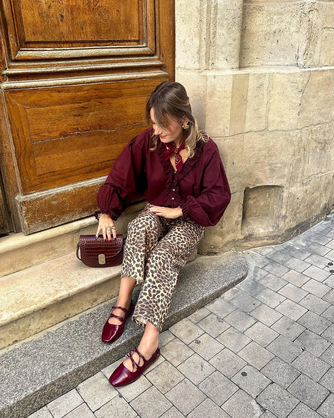 Burgundy blouse with spotted wide trousers and matching accents