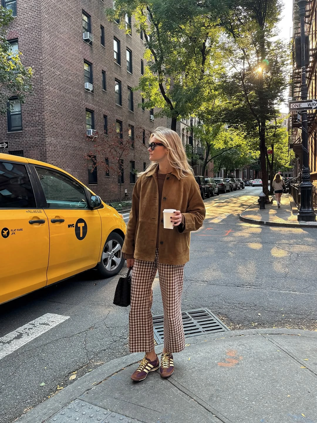 Brown jacket with checked trousers and dark accessories