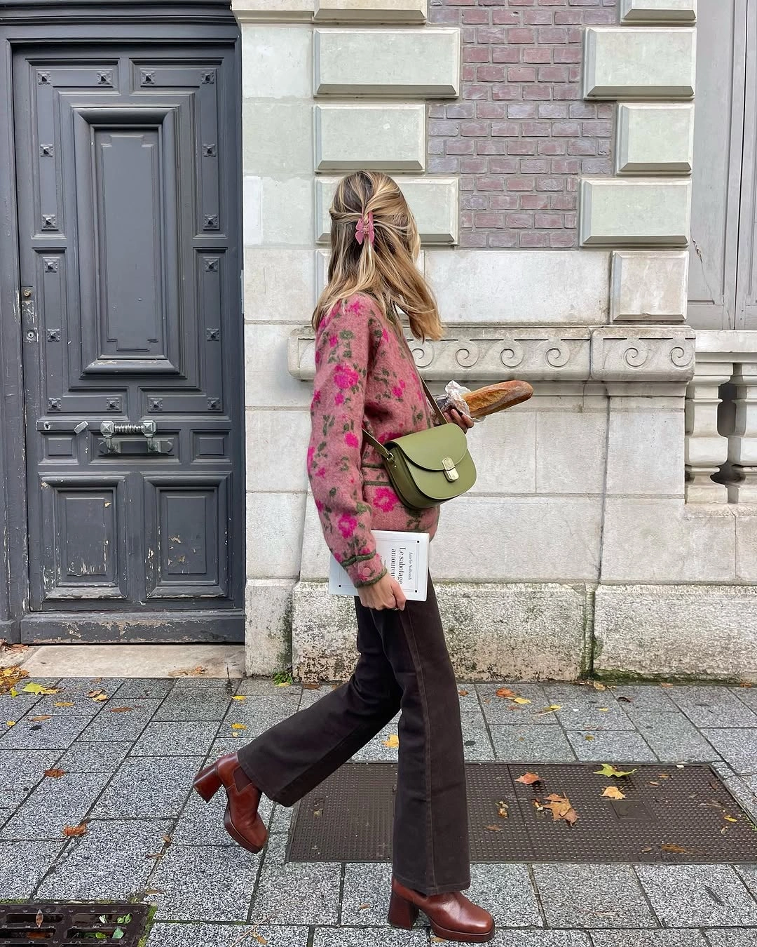 Pink floral cardigan with brown trousers and green bag