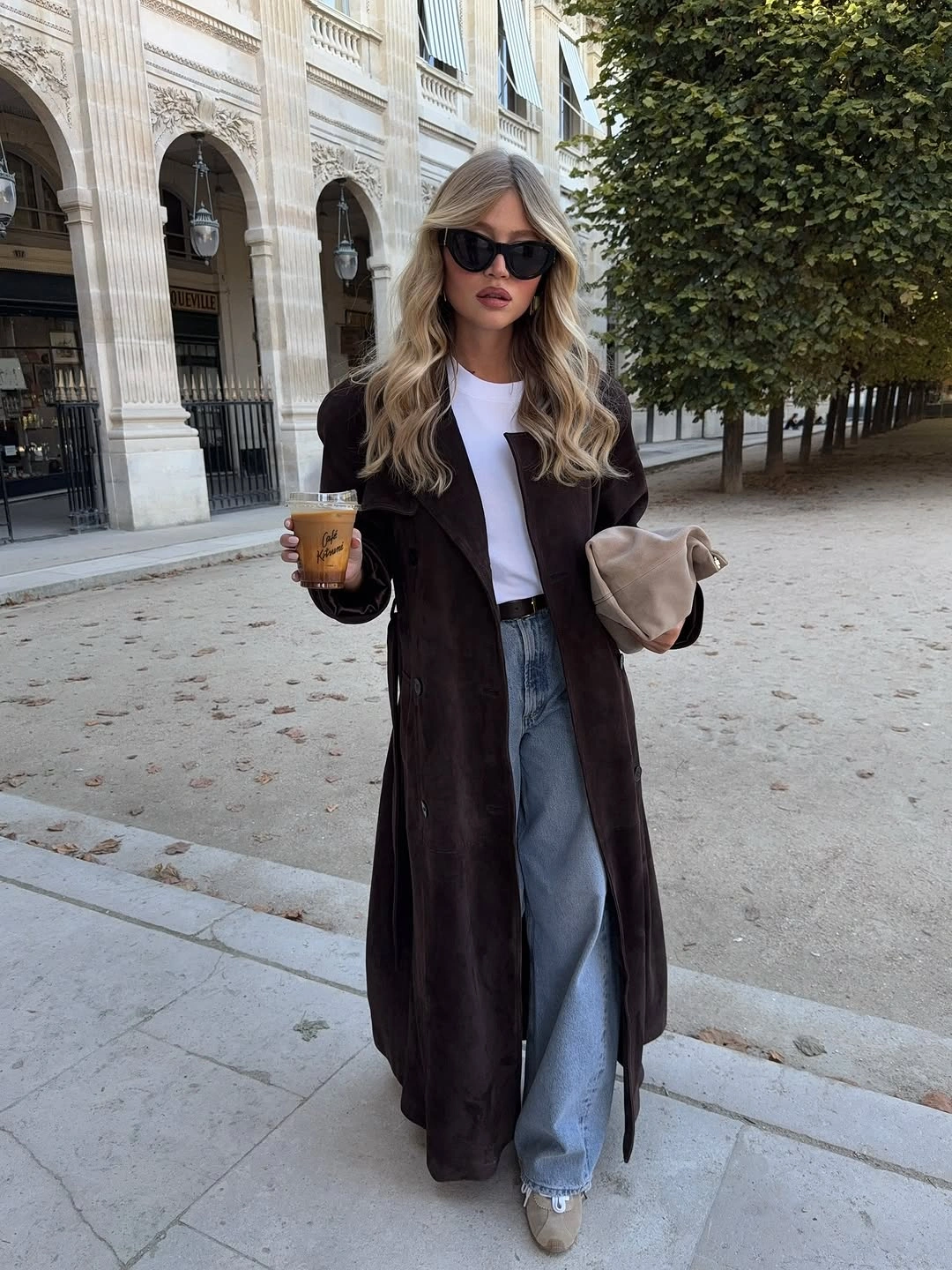 Long dark coat with white top and wide blue jeans