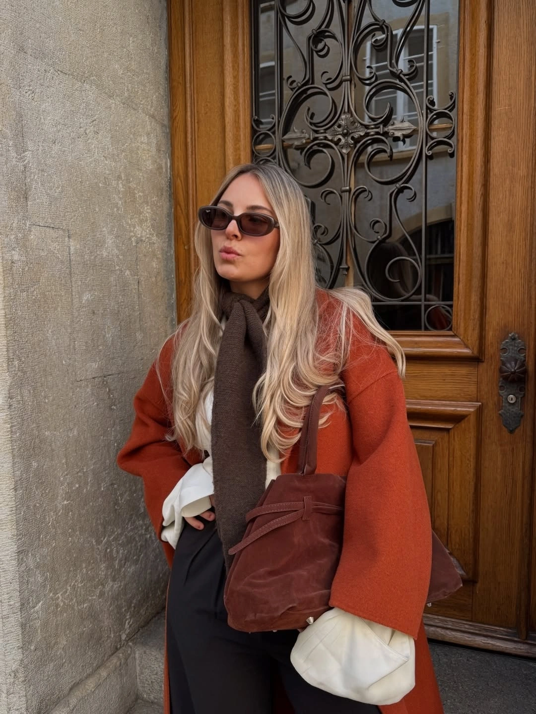 Rust coat with brown scarf and burgundy accessories