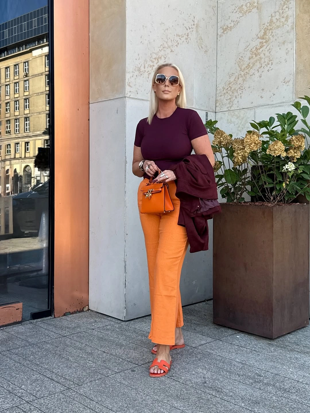 Burgundy top with orange trousers and matching accessories