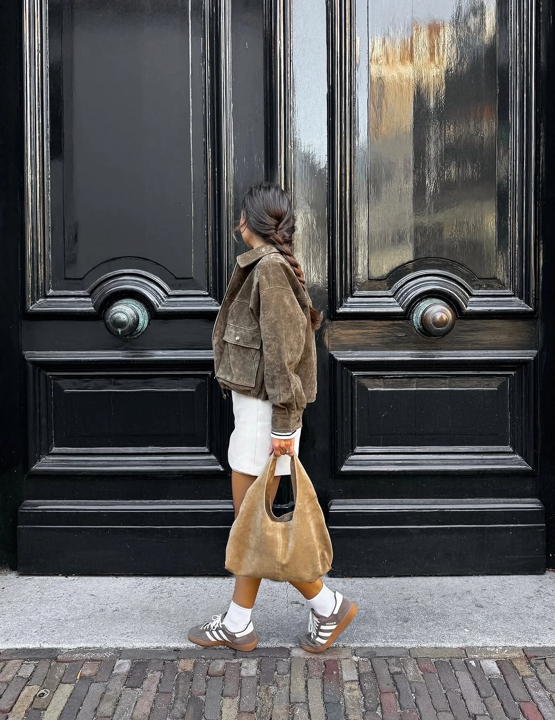 Short brown jacket with pale hem and warm sandals