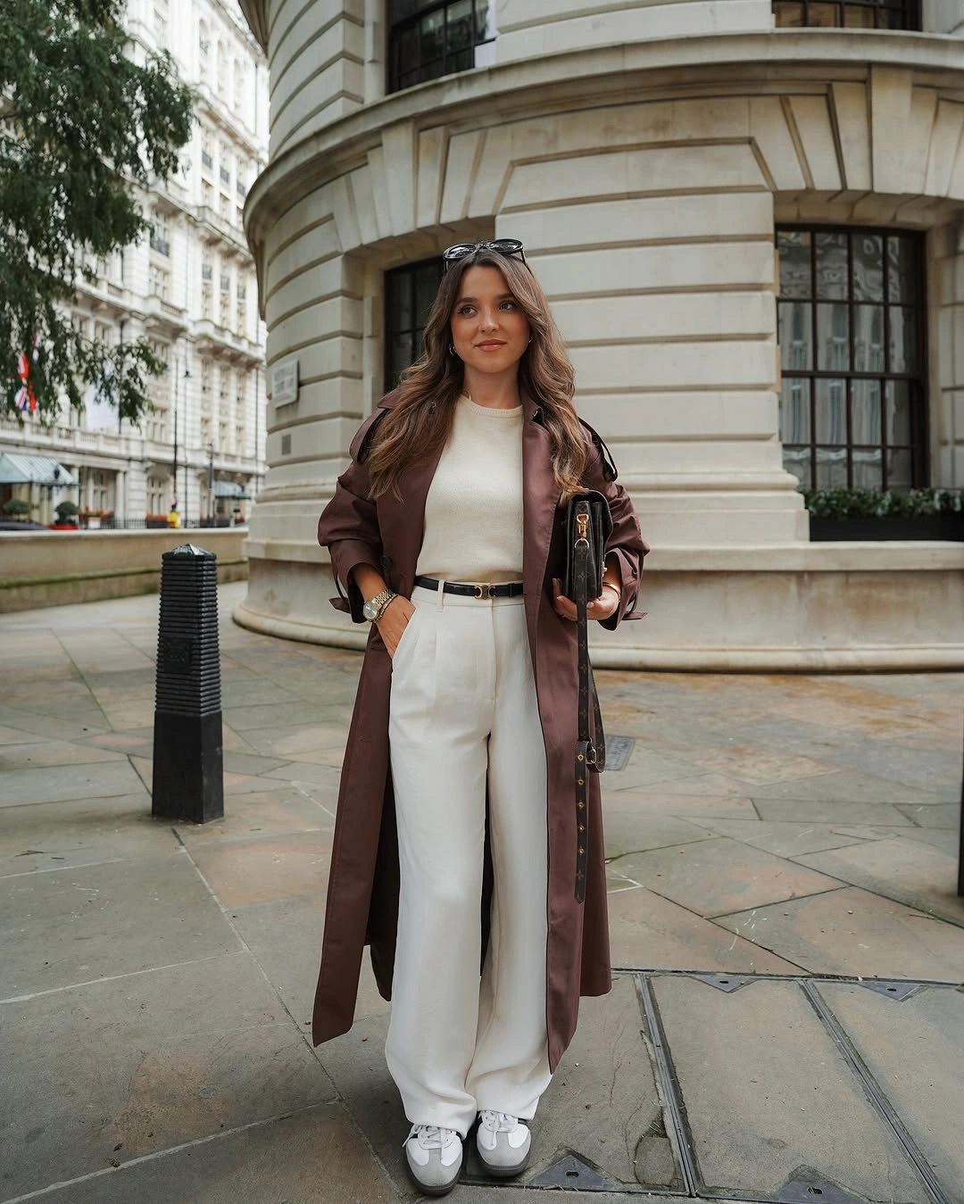 Long brown coat with white top and wide white trousers
