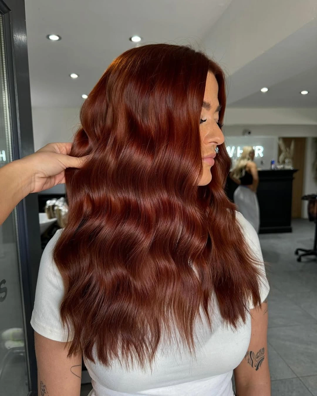Long deep auburn hair with pronounced waves