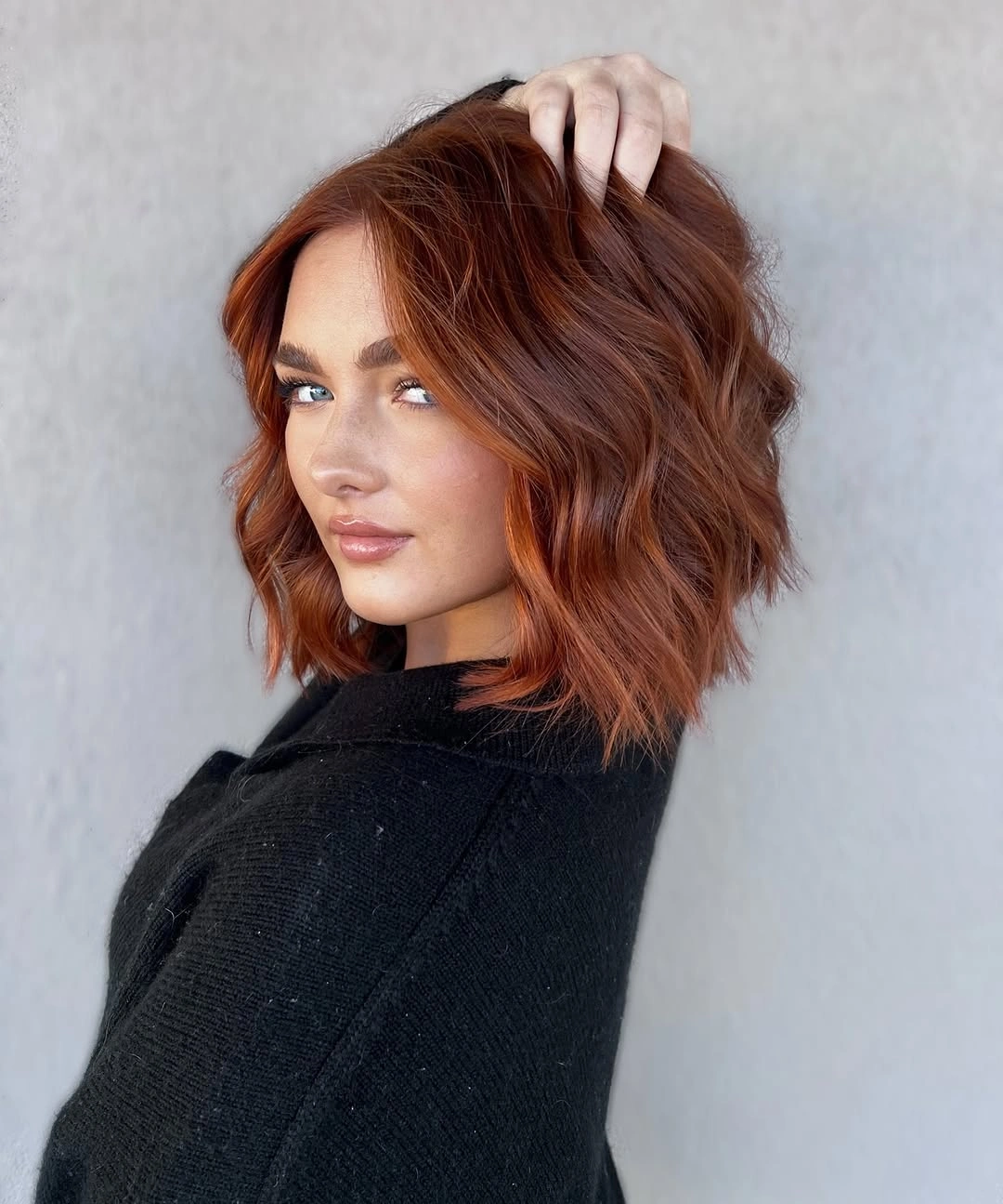 Short copper bob with tousled waves and side sweep