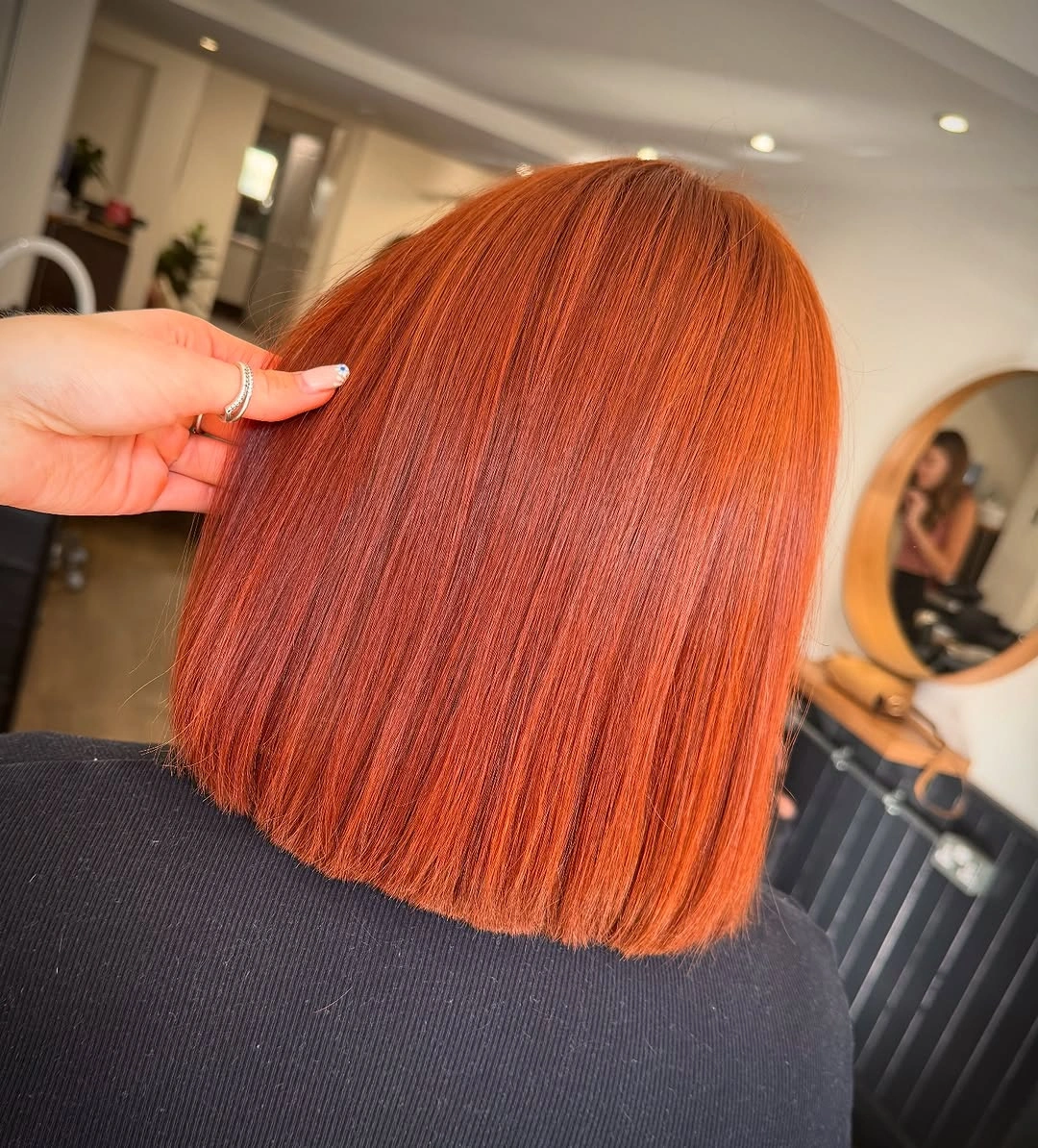 Bright copper orange color on a short straight bob