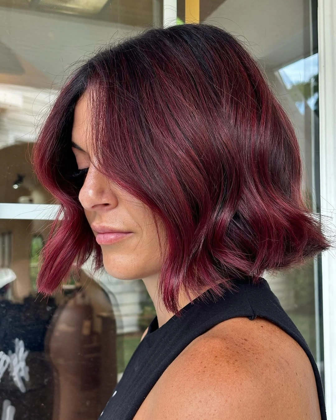 Short burgundy bob with side-swept fringe