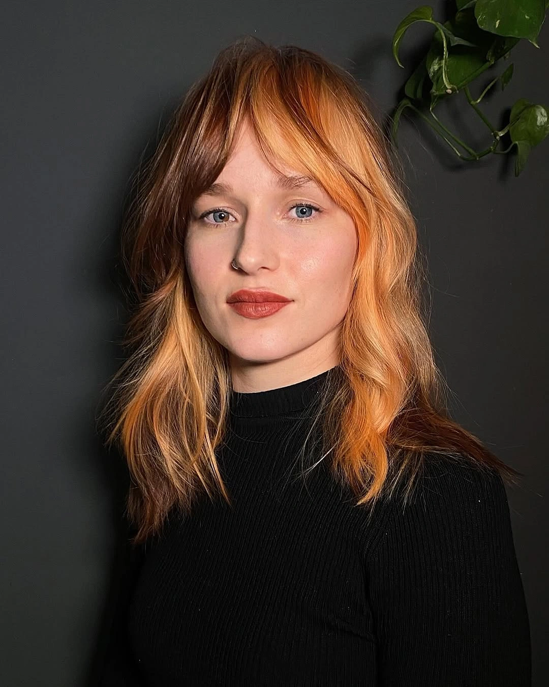 Shoulder-length copper hair with golden face-framing pieces