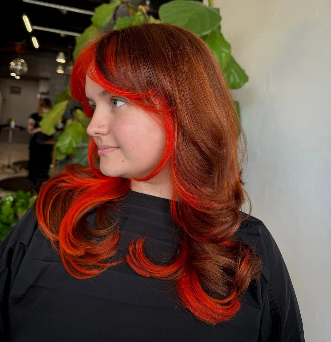 Dark brown hair with vivid red face-framing panels