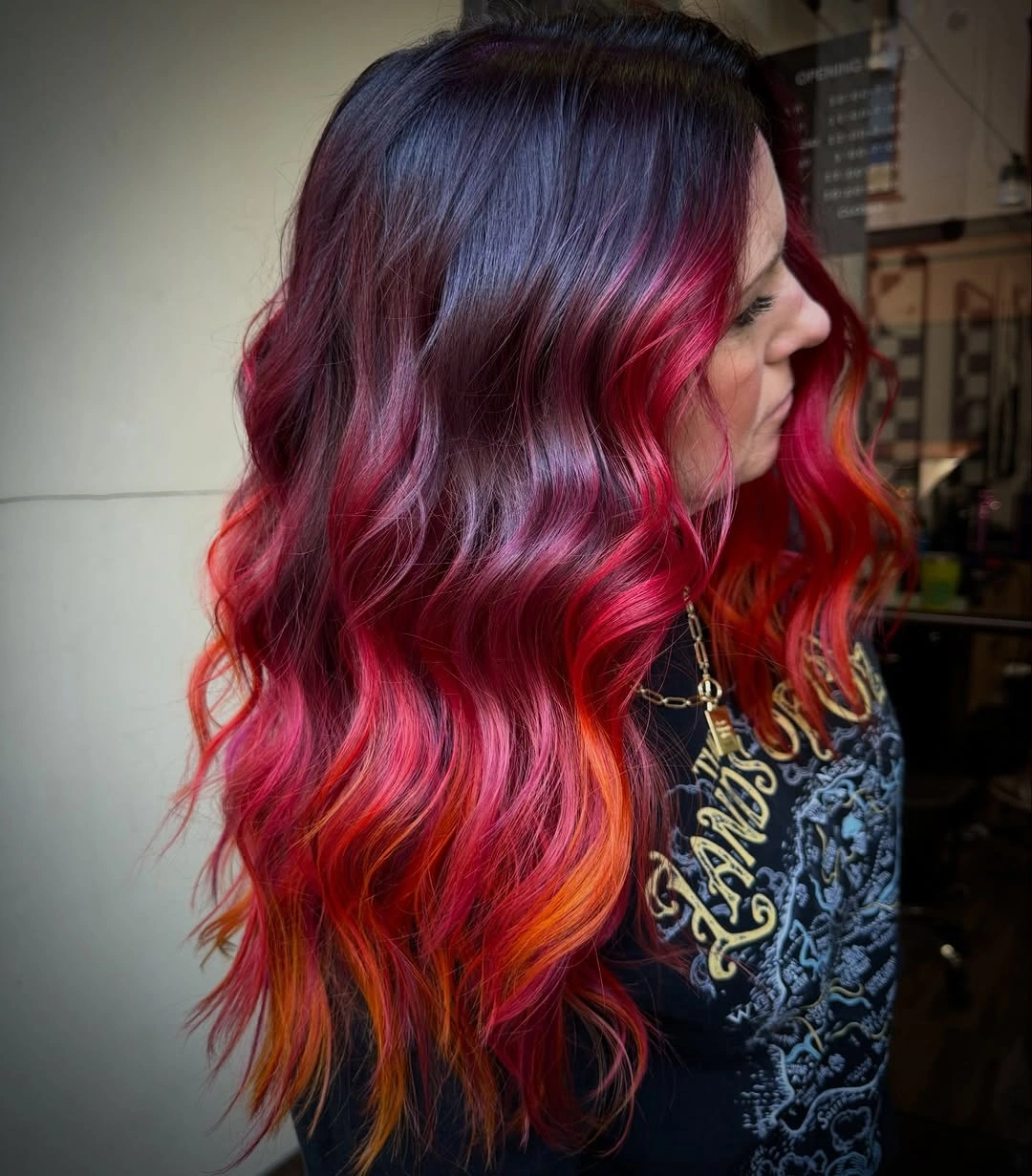 Long dark waves with vivid red pink purple and orange streaks