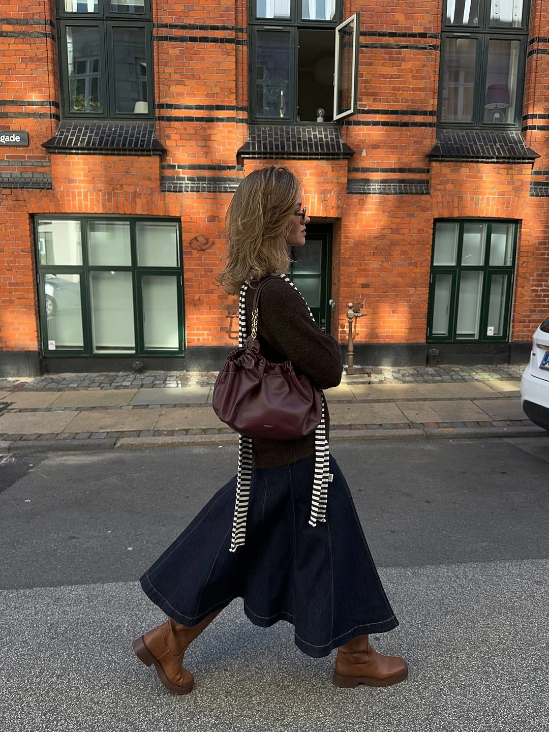 Cream cape with taupe mini skirt and black boots