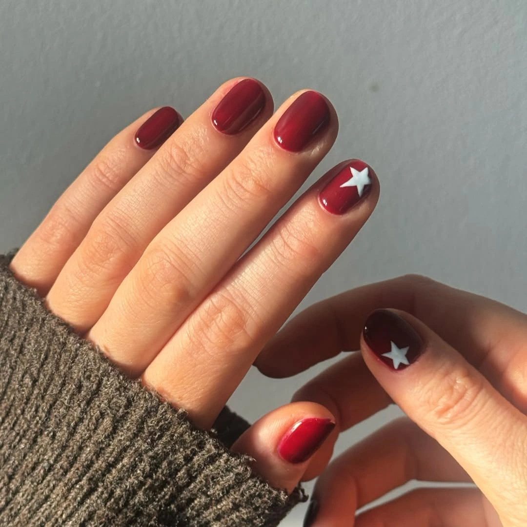 short rounded bright red nails with white star accents