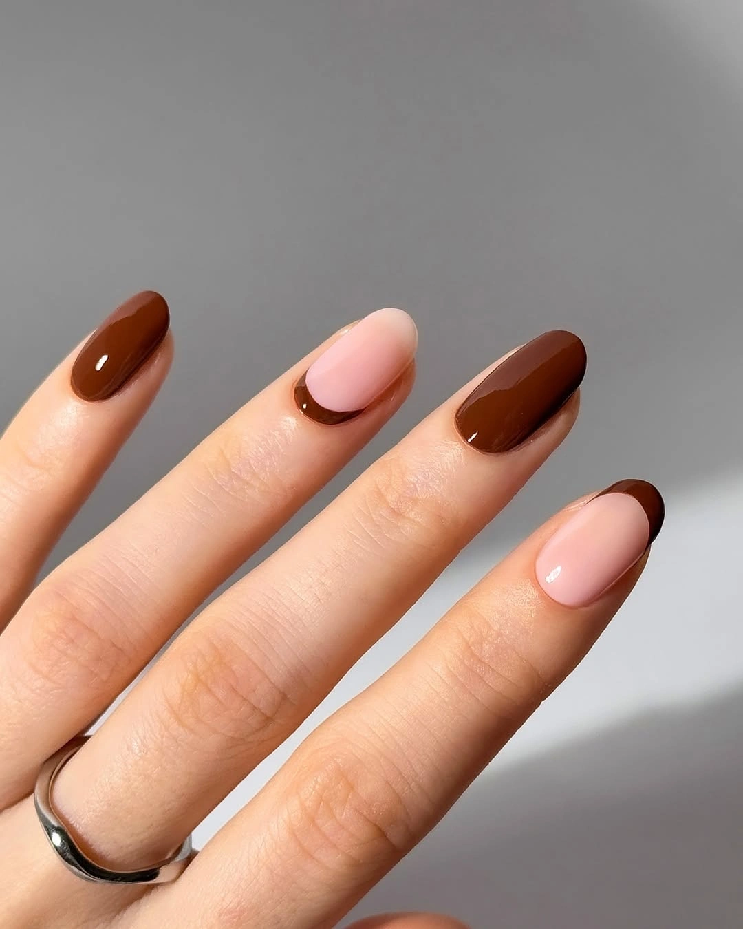 medium almond brown nails with nude curved French tips