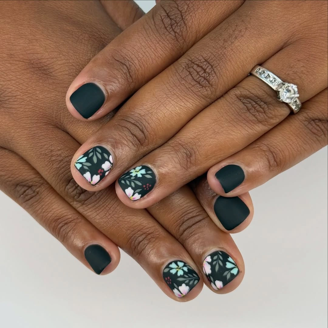 short rounded deep teal nails with compact floral accents