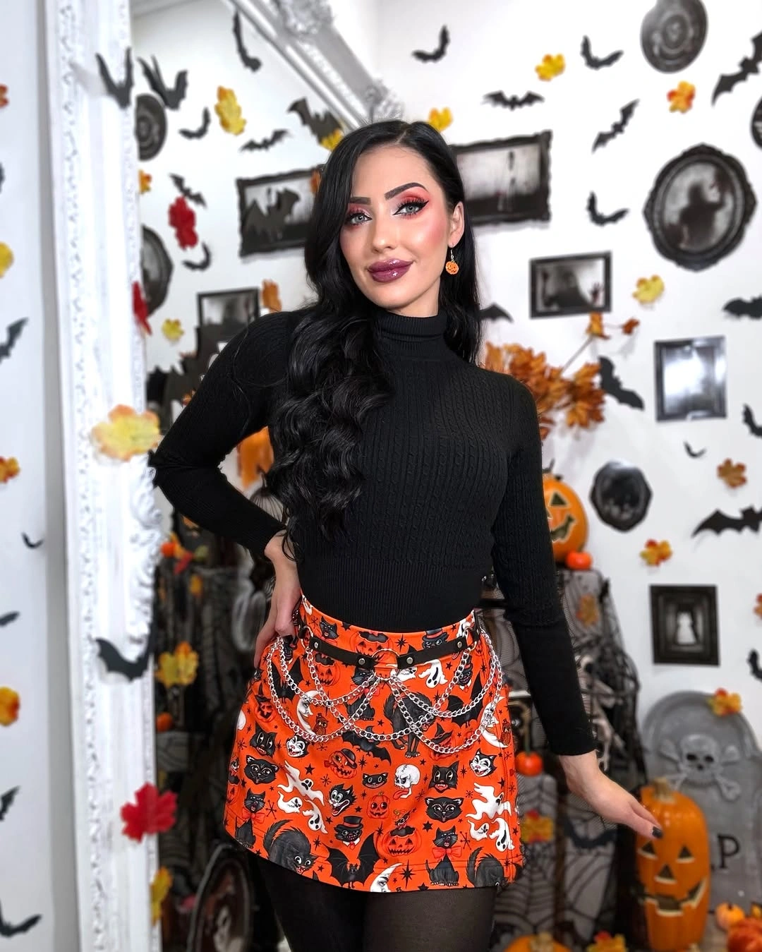 black outfit with fitted high-neck top with short printed skirt and opaque tights