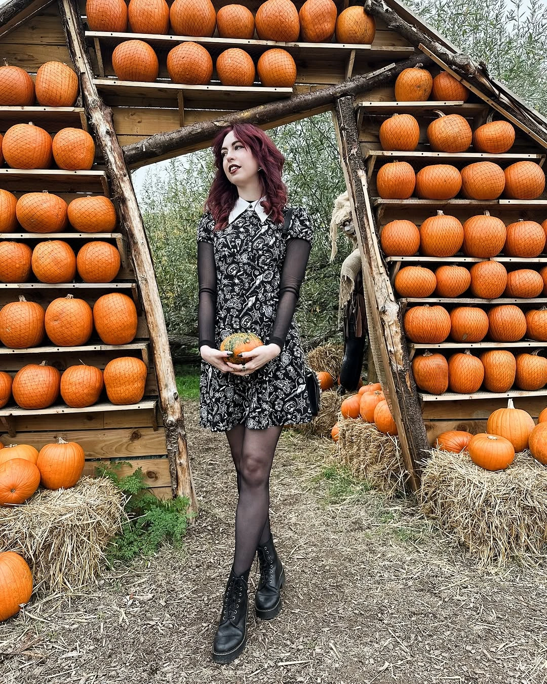 black outfit with short fitted patterned dress with long sleeves and tights