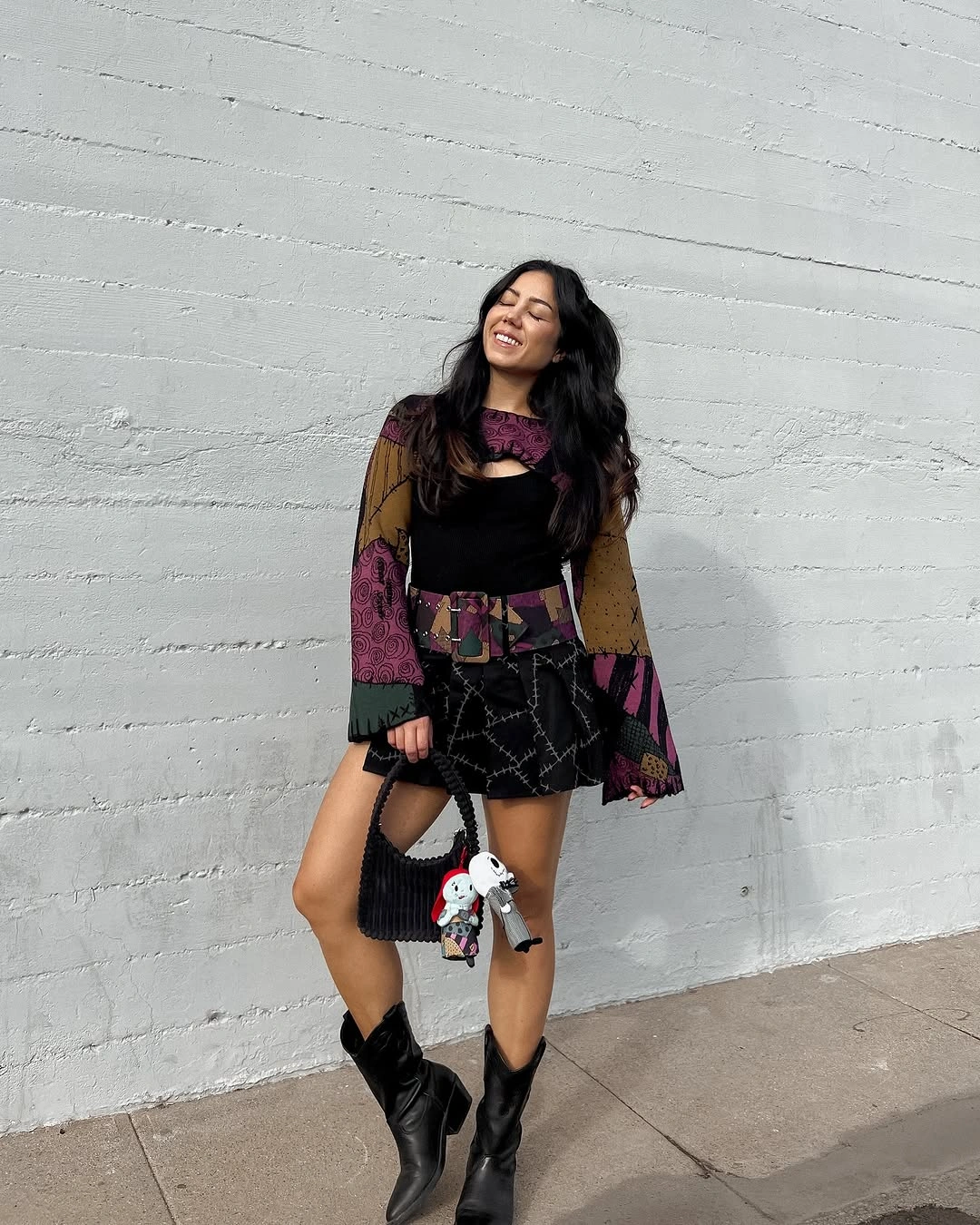 black outfit with short fitted base with flared or translucent sleeves and boots