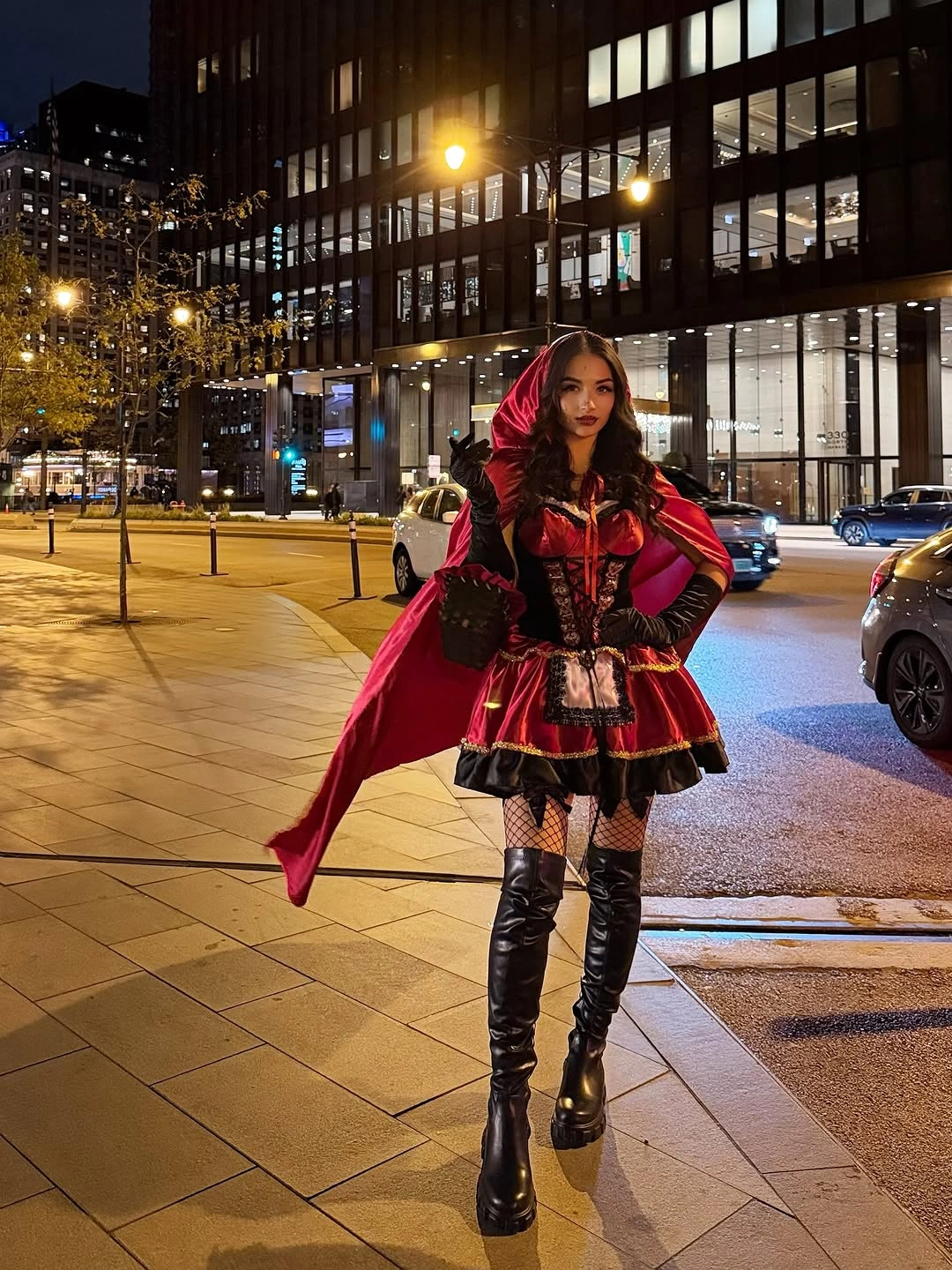 red outfit with fitted dark center with trailing red outer layer and tall boots