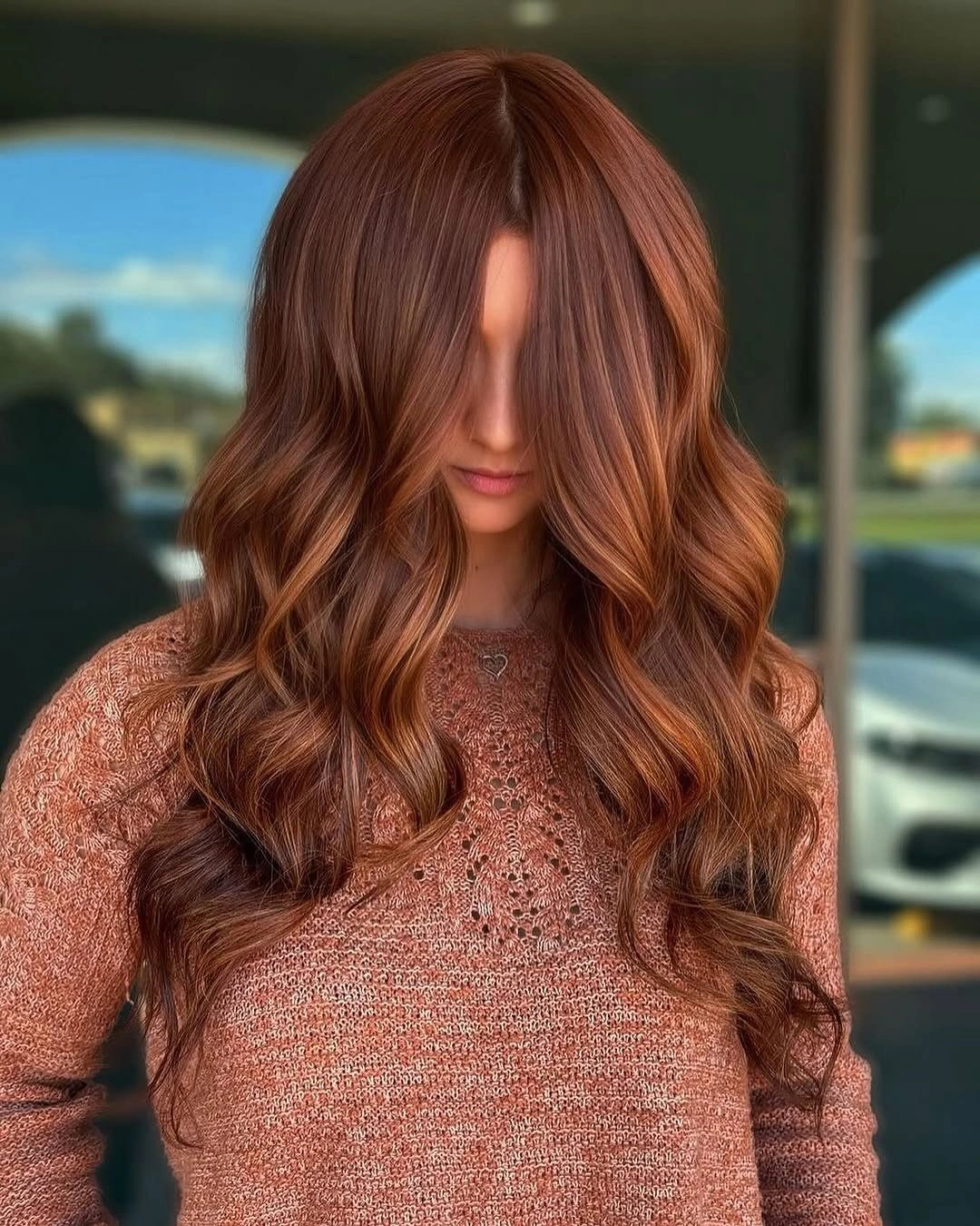 Long auburn waves with brighter copper ribbons through front sections