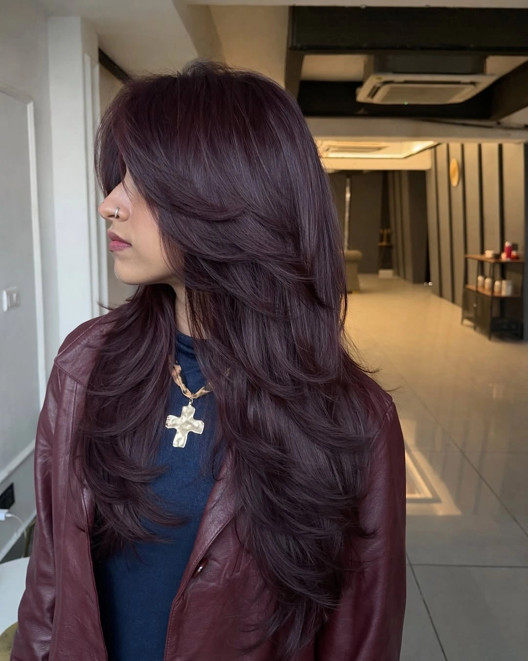 Long dark plum-brown waves with a visible violet cast