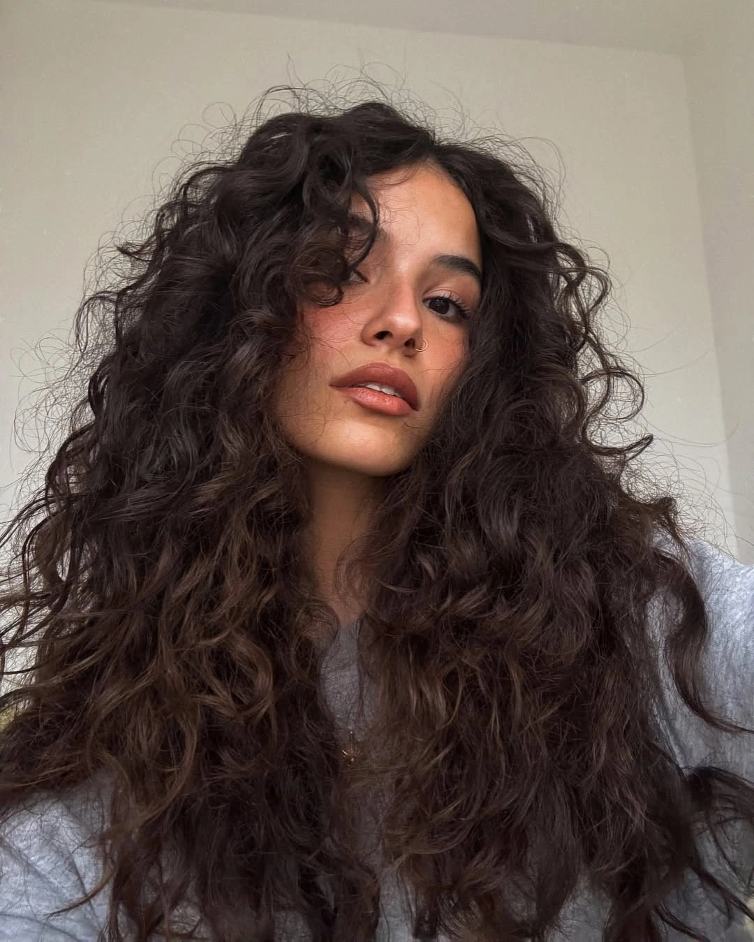 Very long curly hair with dense volume from crown to ends