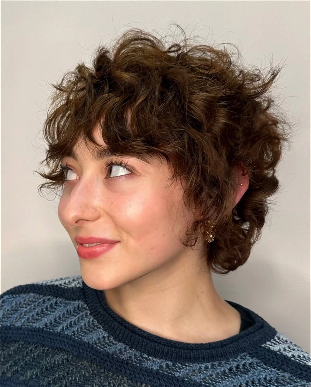 Short curly pixie with cropped sides and textured top fringe
