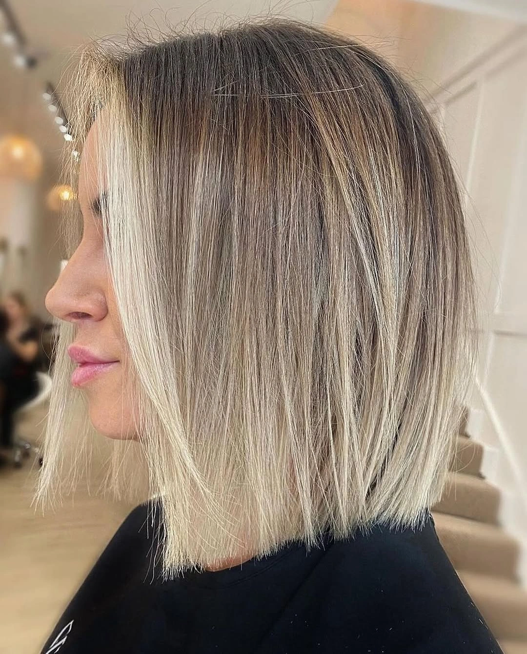 Straight pale blonde bob with crisp blunt lower perimeter