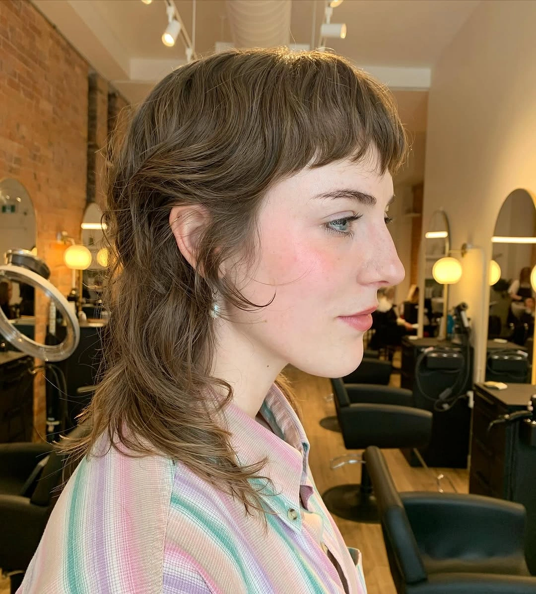 Short straight bangs with longer softly wavy hair at back