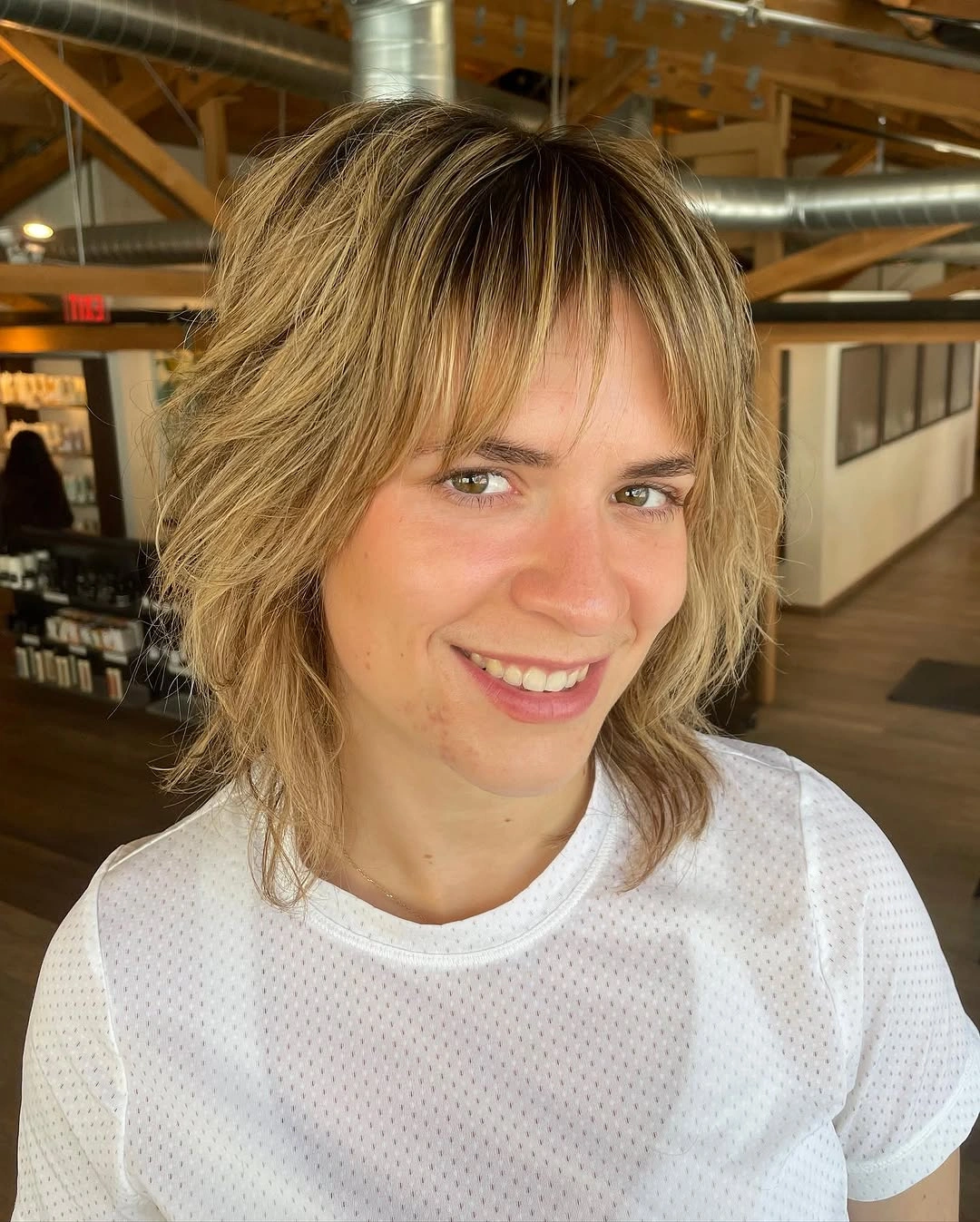 Shoulder-length layered hair with long center-opening curtain fringe