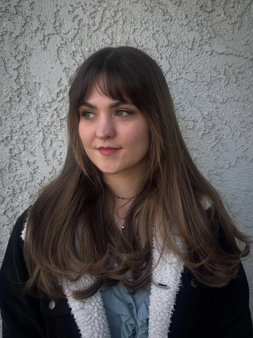 Long mostly straight hair with light wispy fringe and curved ends