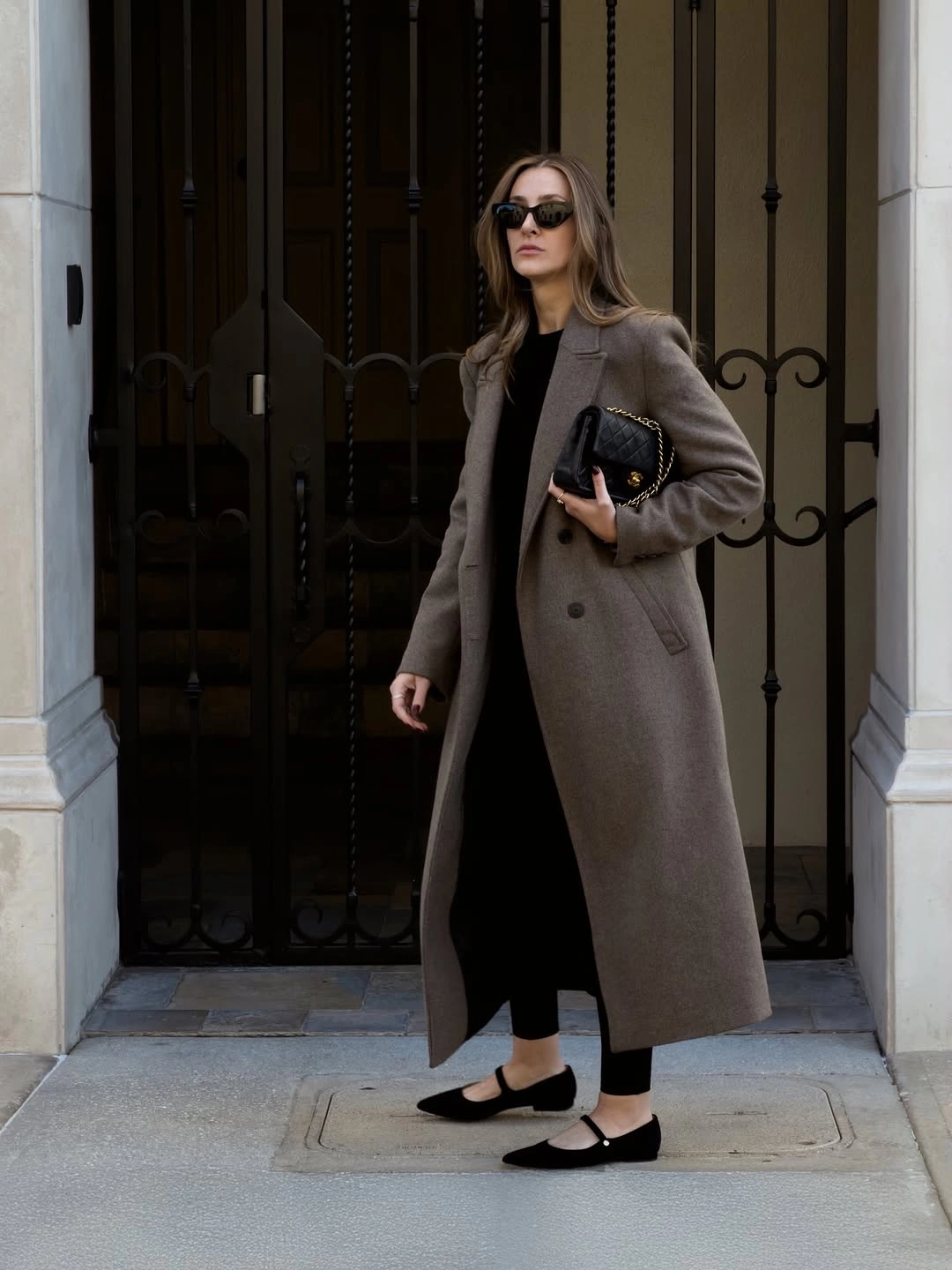 Long taupe-gray coat over black base with Mary Jane flats