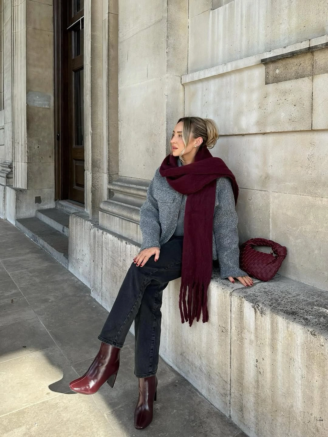 Gray textured coat, burgundy scarf, dark jeans and ankle boots