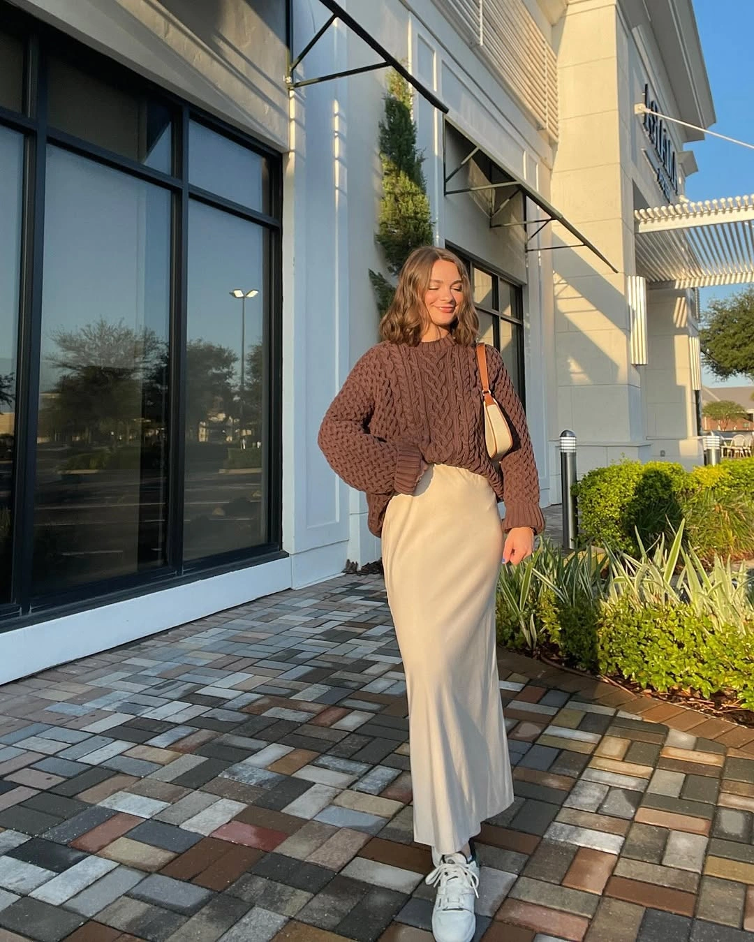 Brown textured sweater, cream long skirt, white sneakers