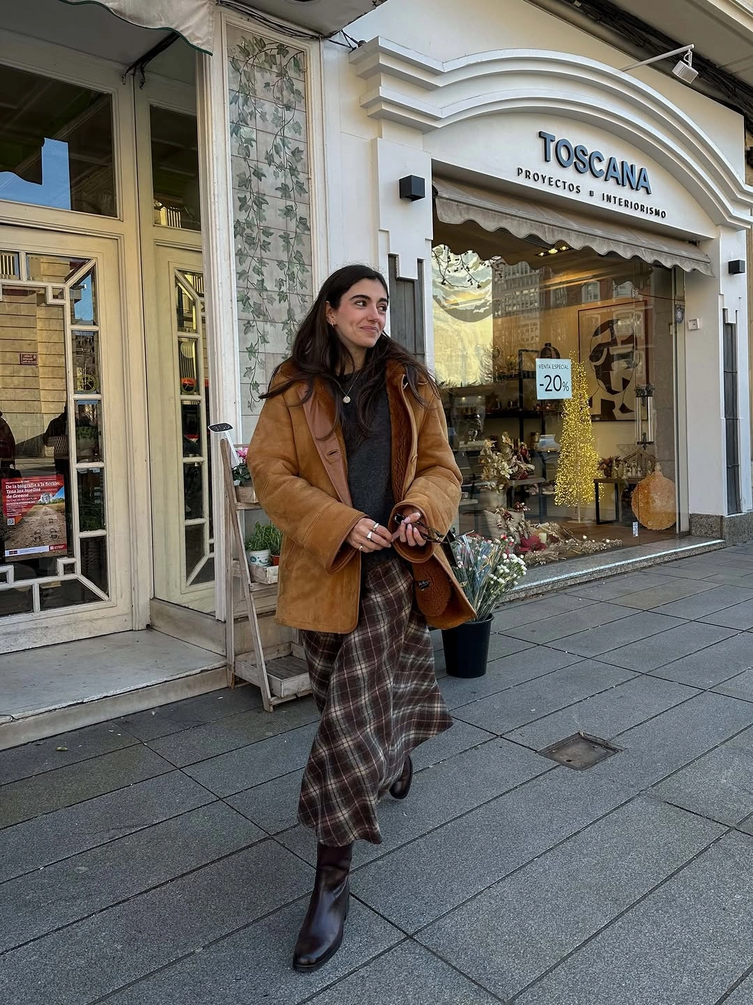 Tan jacket, brown plaid long skirt, brown boots and bag