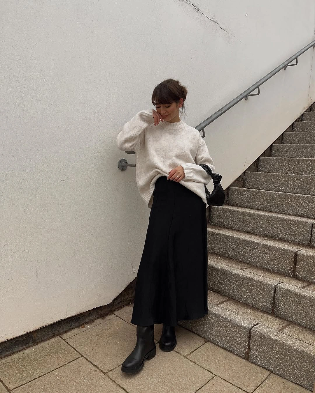 Cream oversized sweater, long black skirt, black ankle boots