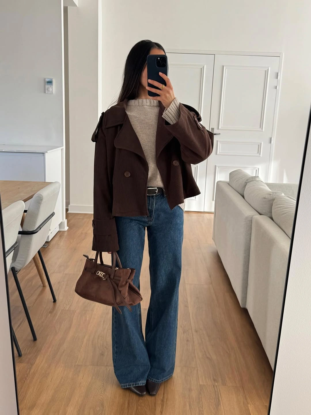 Cropped brown jacket with pale knit and wide blue jeans