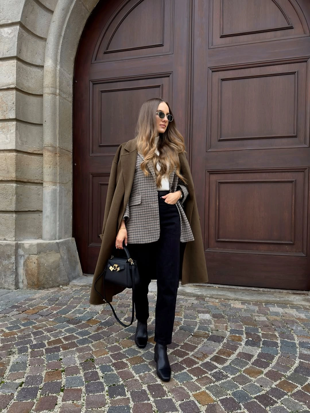 Olive-brown coat with checked blazer and black ankle boots