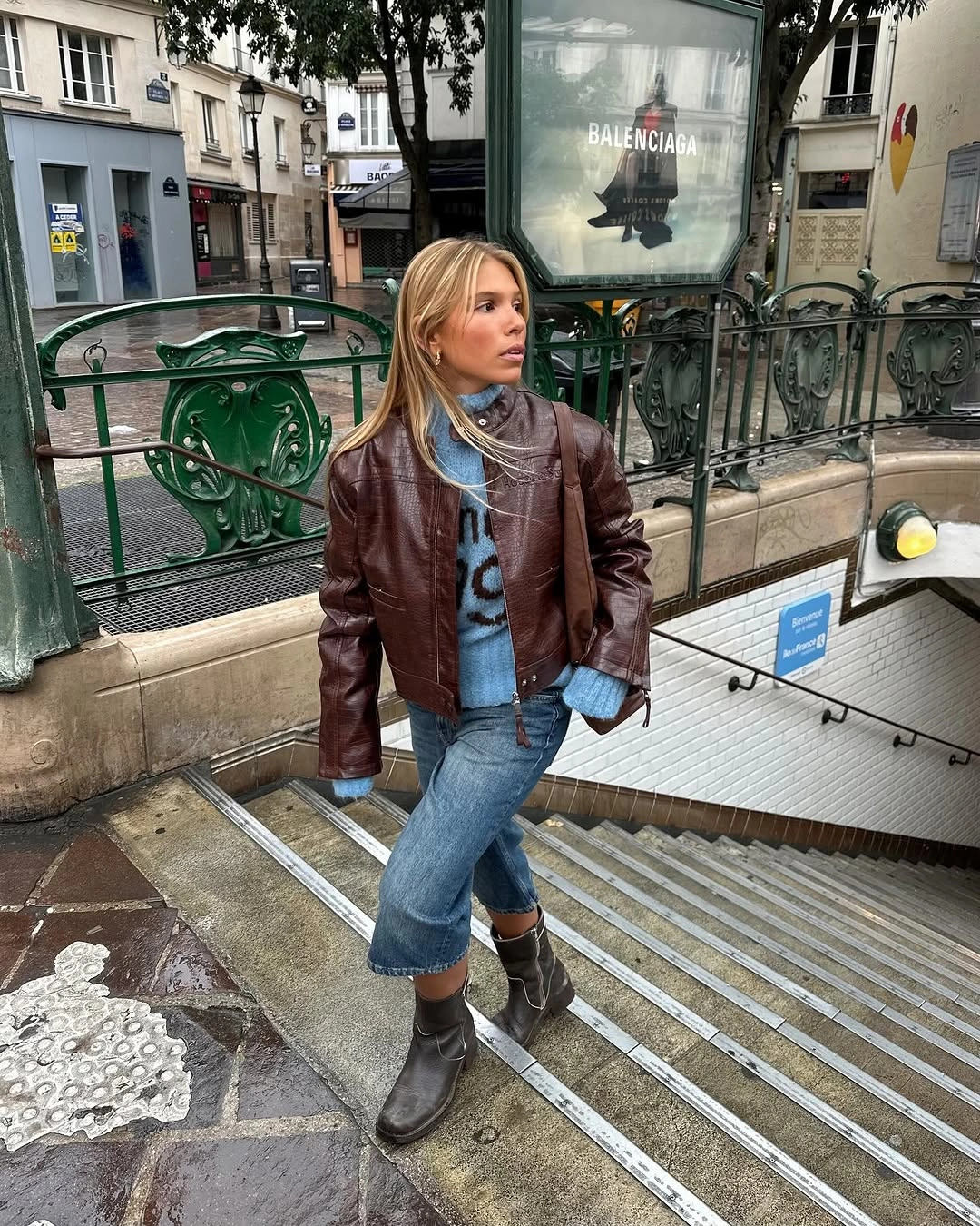 Cropped burgundy jacket with cuffed blue jeans and dark ankle boots