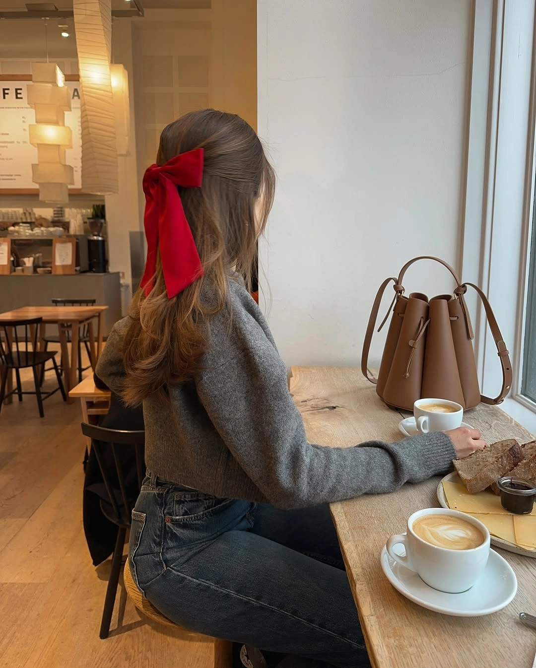 Gray knit and dark denim with large red hair bow