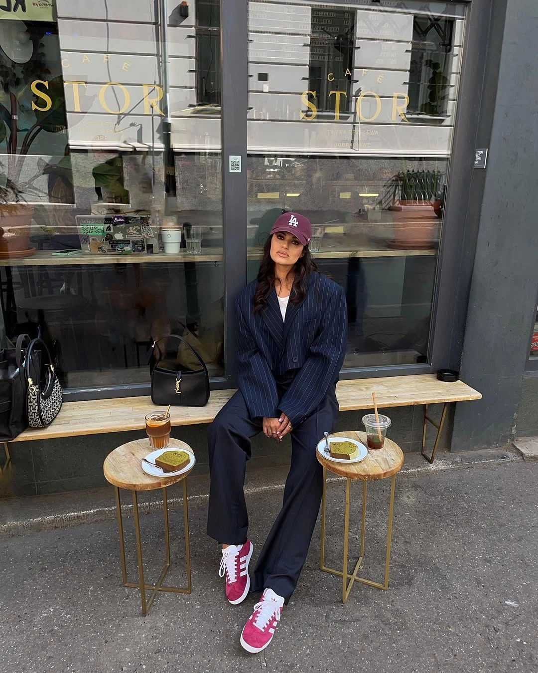 Pinstriped blazer and wide trousers with burgundy cap and pink-red sneakers