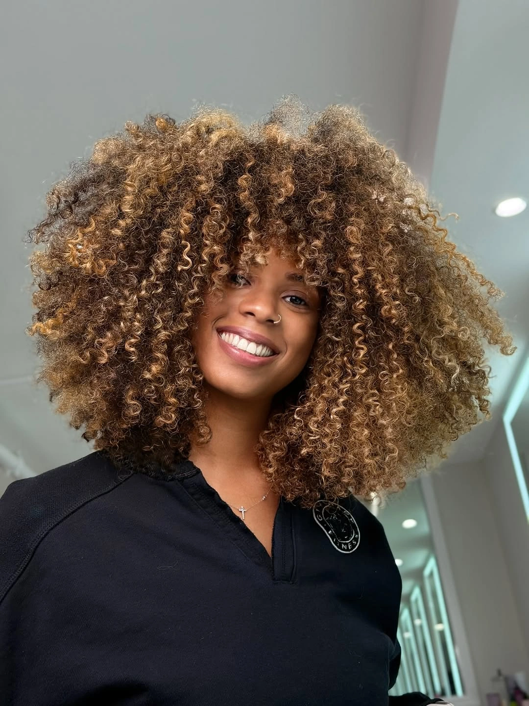 Rounded curls with dark base and golden blonde pieces