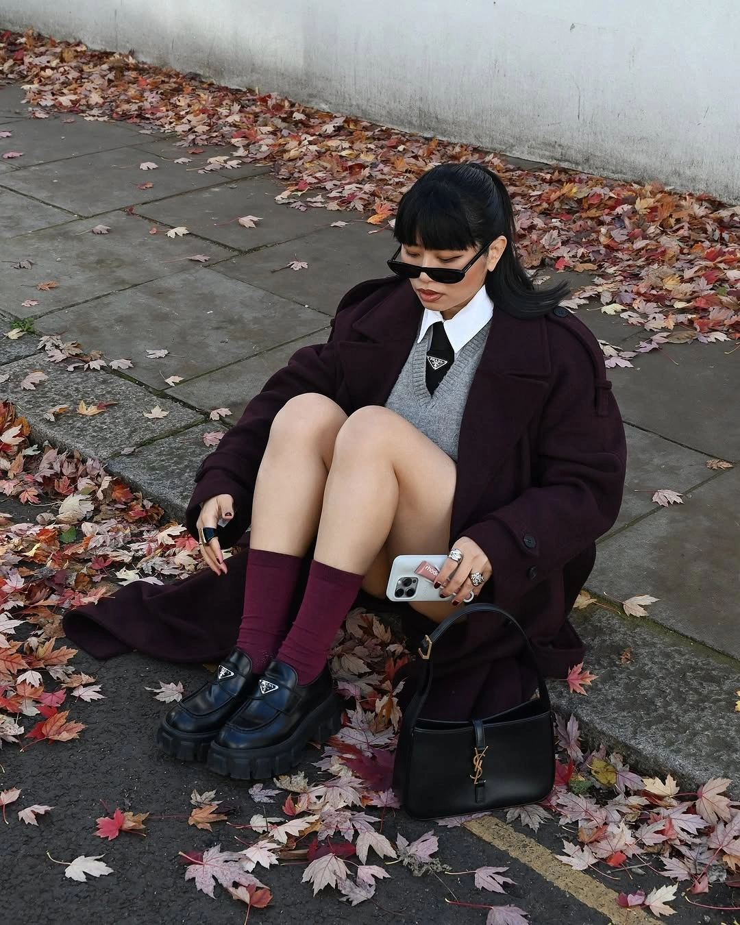 Burgundy long coat with gray vest, socks, and loafers